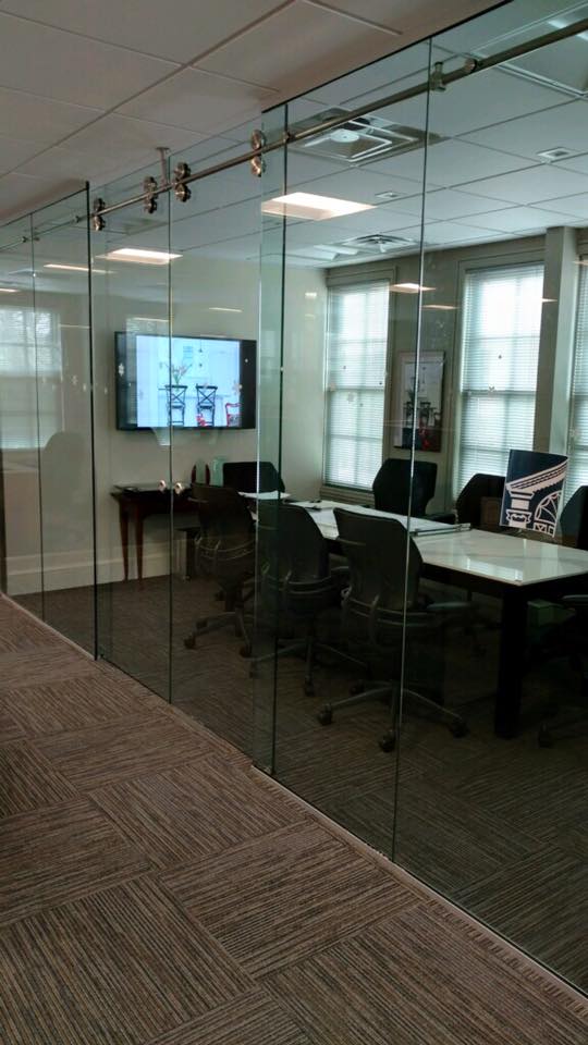 Modern glass office door with clean lines and privacy. Glass office conference room door with sleek frameless design for corporate spaces.