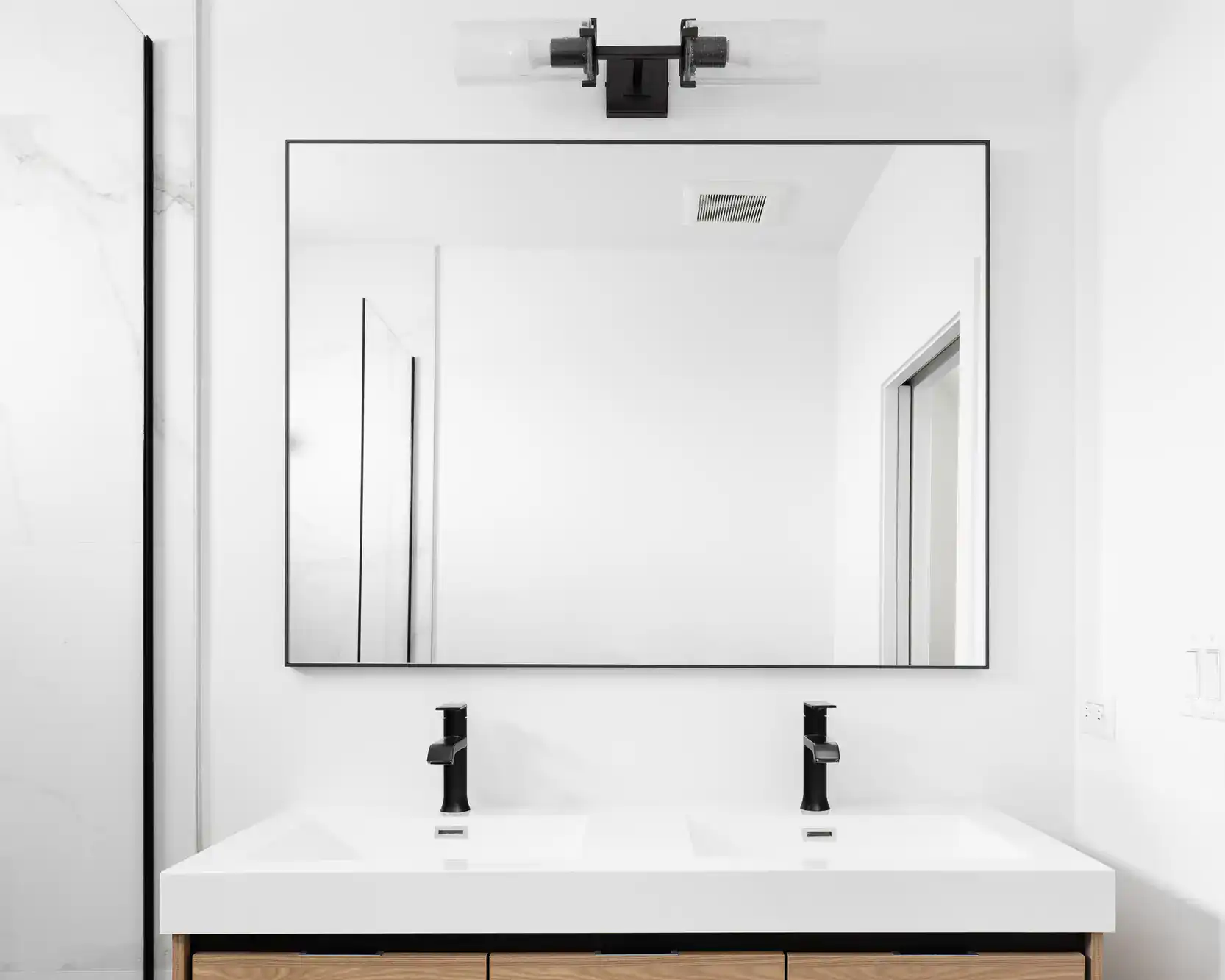 High-quality glass shower door with black hardware for contemporary bathrooms.