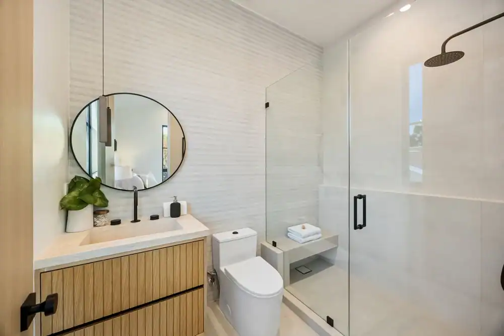 Elegant glass shower enclosure with modern bathroom fixtures.